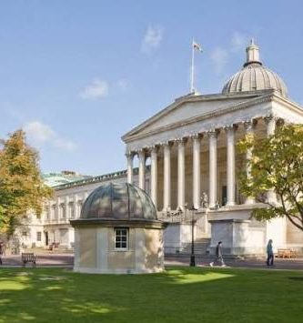 University College London External view of an historical building with columns at the front and domed roof surrounded by greenery