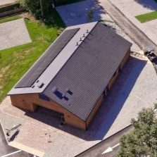 Black Horse Farm Aerial view of shower/toilet block, surrounded by greenery and parking area