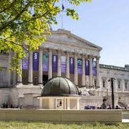University College London Front view of historic building with columns and small domed building, surrounded by greenery