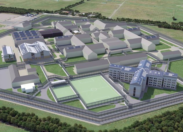 Aerial view of a prison layout with multiple buildings and surrounding green areas.