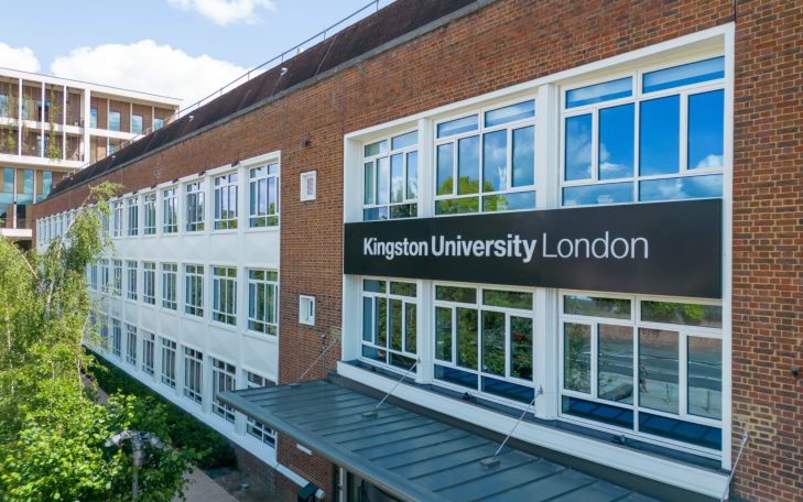Exterior of Kingston University London building with large windows and signage.